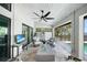 Inviting covered patio with brick flooring, ceiling fan, outdoor seating, and water views at 1820 Jamaica Way, Punta Gorda, FL 33950