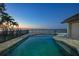 Inviting pool area with a serene bay view and brick paver patio under a clear sky at 1820 Jamaica Way, Punta Gorda, FL 33950
