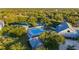 Community pool and clubhouse area with tennis courts and lush trees at 19375 Water Oak Dr # 106, Port Charlotte, FL 33948