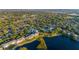 Scenic aerial shot of the community, showcasing condos, lake, mature landscaping, and neighborhood at 19375 Water Oak Dr # 106, Port Charlotte, FL 33948