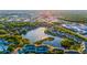 Breathtaking aerial view of community with lakeside condos surrounded by lush greenery and city views in the distance at 19375 Water Oak Dr # 106, Port Charlotte, FL 33948