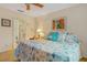Cozy bedroom with a comfortable bed adorned with themed pillows and bedding, complemented by natural light and a ceiling fan at 19375 Water Oak Dr # 106, Port Charlotte, FL 33948