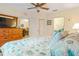 Tranquil bedroom with a comfortable bed, dresser, and views leading to the dining area and bathroom at 19375 Water Oak Dr # 106, Port Charlotte, FL 33948