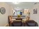 Charming dining area adjacent to the kitchen, featuring a wooden table with seating for four and natural light at 19375 Water Oak Dr # 106, Port Charlotte, FL 33948