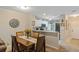 Cozy dining area with a wooden table, seating for four, and a view of the kitchen with granite countertops at 19375 Water Oak Dr # 106, Port Charlotte, FL 33948