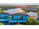 Beautiful view of aqua condo buildings with covered parking and a tranquil lake in the background at 19375 Water Oak Dr # 106, Port Charlotte, FL 33948