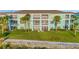 Condo units offering a waterfront view with private outdoor patios and lush tropical landscaping at 19375 Water Oak Dr # 106, Port Charlotte, FL 33948