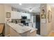 Modern kitchen featuring granite countertops, stainless steel appliances, and white cabinetry at 19375 Water Oak Dr # 106, Port Charlotte, FL 33948