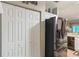 Spacious kitchen features stainless steel refrigerator, white cabinets and tiled floors at 19375 Water Oak Dr # 106, Port Charlotte, FL 33948
