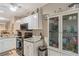 Kitchen features granite countertops, a glass display cabinet, and modern appliances at 19375 Water Oak Dr # 106, Port Charlotte, FL 33948