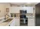 Kitchen with granite countertops, stainless steel appliances, and bright white cabinets at 19375 Water Oak Dr # 106, Port Charlotte, FL 33948