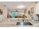 Kitchen with stainless steel sink, granite countertop, and view into living area at 19375 Water Oak Dr # 106, Port Charlotte, FL 33948