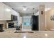 Bright kitchen boasts granite counters, a stainless sink and black appliances at 19375 Water Oak Dr # 106, Port Charlotte, FL 33948