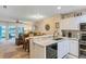 Open-concept kitchen flowing into the dining and living areas with views of the lake from the sliding glass doors at 19375 Water Oak Dr # 106, Port Charlotte, FL 33948