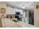Kitchen with granite countertops, stainless steel appliances, and bright white cabinets at 19375 Water Oak Dr # 106, Port Charlotte, FL 33948