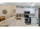 This stylish kitchen features granite counters, modern appliances, and white cabinetry at 19375 Water Oak Dr # 106, Port Charlotte, FL 33948