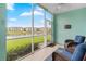 Screened lanai with comfortable seating overlooking a serene pond and well-maintained landscaping at 19375 Water Oak Dr # 106, Port Charlotte, FL 33948