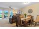 Combined living and dining space boasts water views, ceiling fan, and comfortable seating for seamless entertaining at 19375 Water Oak Dr # 106, Port Charlotte, FL 33948
