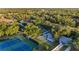 Aerial view of well-kept tennis courts and recreation areas surrounded by lush greenery and mature trees at 19375 Water Oak Dr # 106, Port Charlotte, FL 33948