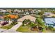 Stunning aerial view of a home with a well-manicured lawn, tile roof, and waterfront access at 211 Lido Dr, Punta Gorda, FL 33950