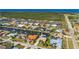 Aerial view of a waterfront community with homes, canals, and lush landscaping near the ocean at 211 Lido Dr, Punta Gorda, FL 33950