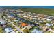 Expansive aerial of homes nestled along canals, offering stunning waterfront living in a vibrant community at 211 Lido Dr, Punta Gorda, FL 33950