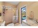 Bathroom featuring glass-enclosed shower and granite vanity overlooking a pool at 211 Lido Dr, Punta Gorda, FL 33950