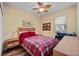 Bedroom features a ceiling fan, natural light and cozy decor with a plaid comforter at 211 Lido Dr, Punta Gorda, FL 33950