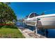 Beautiful waterfront property featuring a private boat dock and lift on a sunny day at 211 Lido Dr, Punta Gorda, FL 33950
