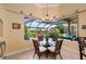 Cozy breakfast nook featuring wicker chairs, a glass table and views of the lanai at 211 Lido Dr, Punta Gorda, FL 33950