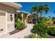Close up exterior shot showing a well maintained home with lush landscaping and a stone walkway at 211 Lido Dr, Punta Gorda, FL 33950