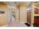 Hallway with neutral tile floor leads past a closet to a bathroom with a shower at 211 Lido Dr, Punta Gorda, FL 33950