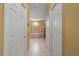 Hallway view featuring white doors and a glimpse into the bathroom with a tub at 211 Lido Dr, Punta Gorda, FL 33950