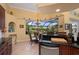 Breakfast nook with view of the pool area and lush gardens via a large picture window at 211 Lido Dr, Punta Gorda, FL 33950