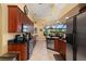 Kitchen with dark wood cabinetry, granite counters, and views into the breakfast nook at 211 Lido Dr, Punta Gorda, FL 33950