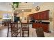 Well-lit kitchen with dark wood cabinets, granite counters and breakfast bar seating at 211 Lido Dr, Punta Gorda, FL 33950