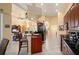 Open kitchen featuring dark wood cabinets, stainless appliances, and breakfast bar at 211 Lido Dr, Punta Gorda, FL 33950