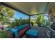 Beautiful and cozy outdoor screened-in lanai with a grill and comfortable seating at 211 Lido Dr, Punta Gorda, FL 33950