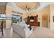 Bright living room with tile floors, ceiling fan, and a large entertainment center at 211 Lido Dr, Punta Gorda, FL 33950