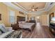 Spacious main bedroom features tray ceilings, wood floors, a ceiling fan and ensuite bathroom at 211 Lido Dr, Punta Gorda, FL 33950