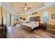 Large main bedroom with tray ceiling, wood floors, and sitting area at 211 Lido Dr, Punta Gorda, FL 33950