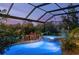 Lush, private pool area featuring a unique spa, waterfall feature, and tranquil atmosphere, creating the ultimate relaxation space at 211 Lido Dr, Punta Gorda, FL 33950