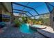 Sparkling pool and spa surrounded by tropical landscaping and a screened enclosure at 211 Lido Dr, Punta Gorda, FL 33950