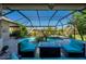 A screened-in lanai offers a relaxing view of the pool, spa and lush landscaping at 211 Lido Dr, Punta Gorda, FL 33950