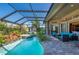 Lovely screened lanai offering a pool, spa, and comfortable seating for outdoor relaxation at 211 Lido Dr, Punta Gorda, FL 33950