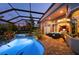 Stunning outdoor oasis featuring a luxurious pool, hot tub, screened lanai, and comfortable seating area at 211 Lido Dr, Punta Gorda, FL 33950