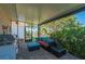 Relaxing screened lanai featuring a grill, seating, and views of the lush backyard at 211 Lido Dr, Punta Gorda, FL 33950