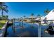 Scenic waterfront view with lush tropical landscaping, private docks, and boat lifts at 211 Lido Dr, Punta Gorda, FL 33950