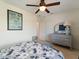 Bedroom with ceiling fan, tiled floors, and a floral comforter at 21444 Higgs Dr, Port Charlotte, FL 33952
