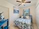 Bedroom with a ceiling fan, light walls, and a tropical print bedspread at 21444 Higgs Dr, Port Charlotte, FL 33952